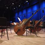 cellos resting on chairs inside building